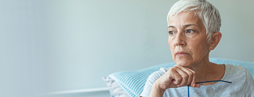 Image of sad senior woman staring off into space